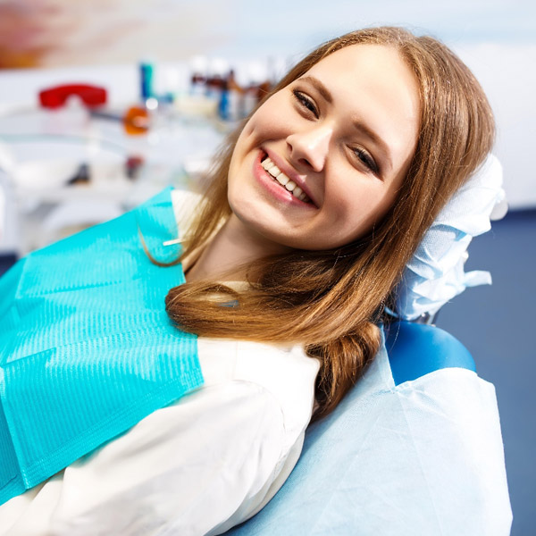 Woman smiling showing her white teeth at the dentist office