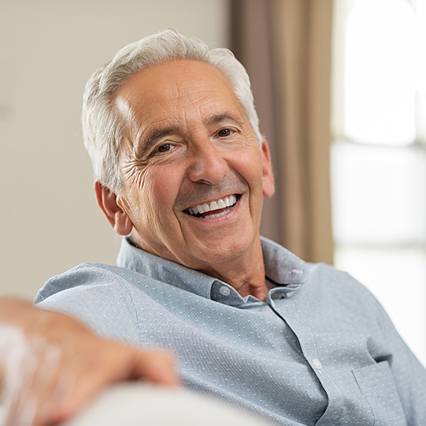 Man smiling showing his white teeth in living room