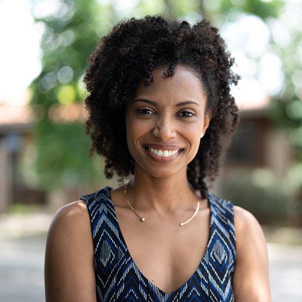 Woman smiling showing her white teeth outdoors