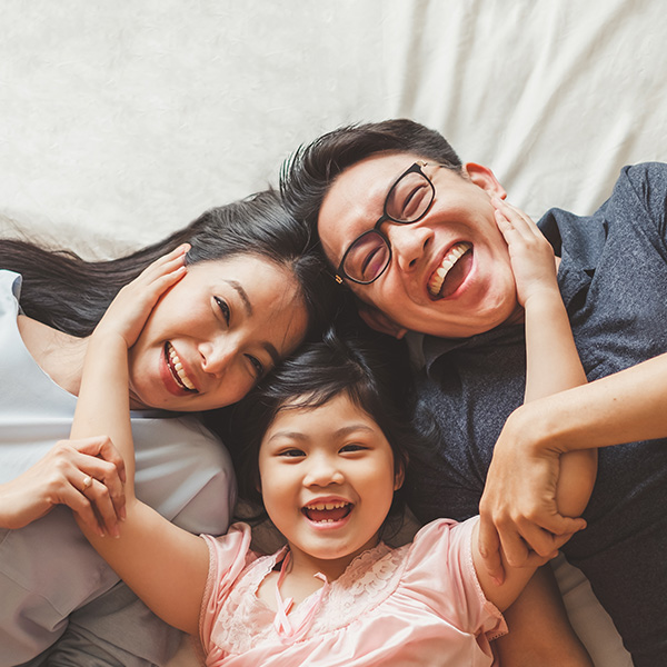 Happy family smiling showing their white teeth