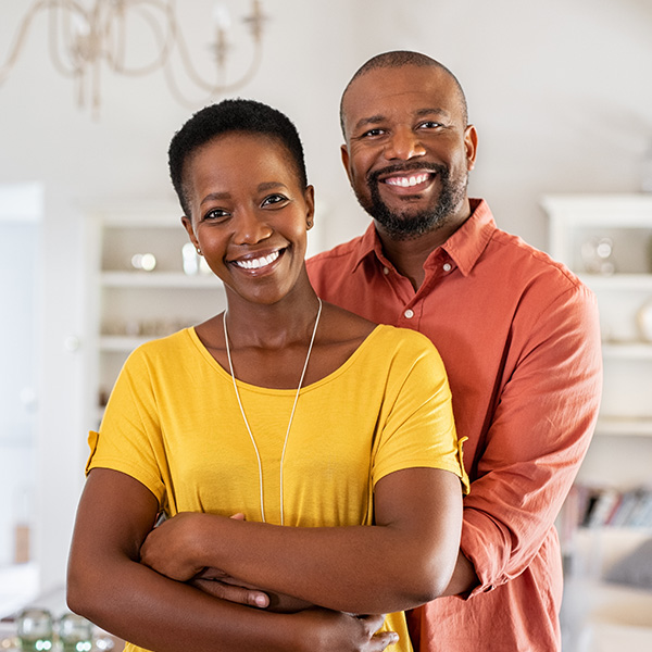 Happy couple smiling and cooking together