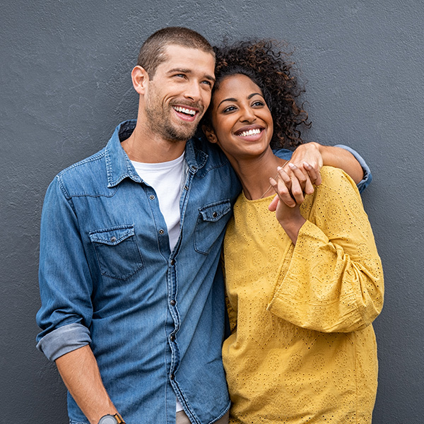 Happy couple smiling, showing their white teeth