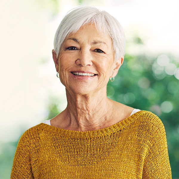 Elderly woman smiling showing her white teeth