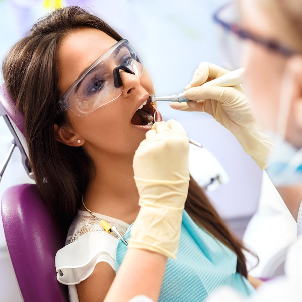 Woman getting a dental cleaning at the dentist office