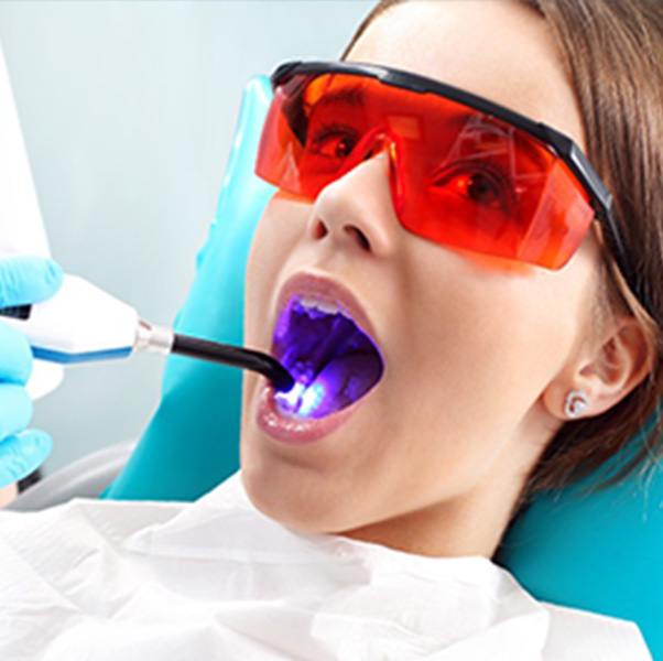 Woman smiling getting her teeth checked at the dentist