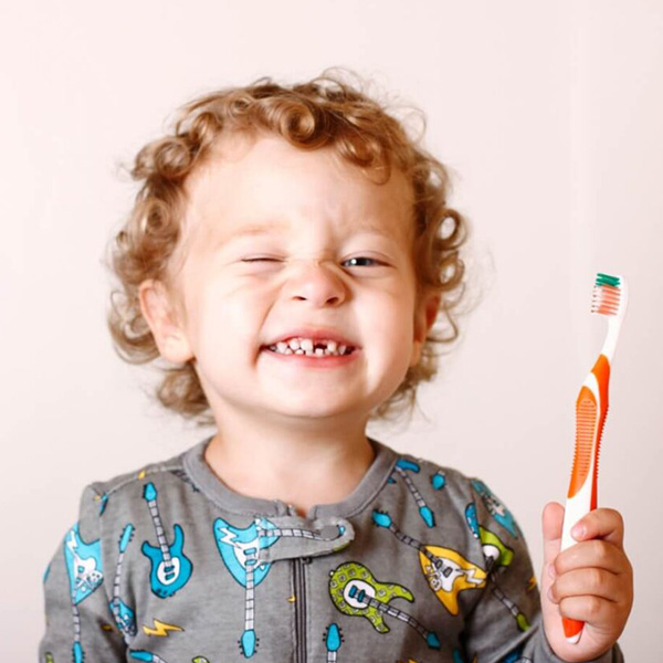 Little boy brushing his teeth for the first time