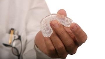 Dentist holding an Invisalign