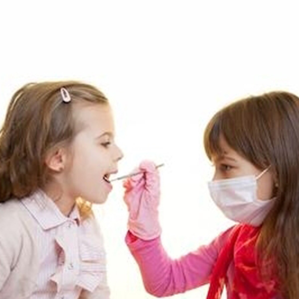 Dentist looking at little girl's teeth