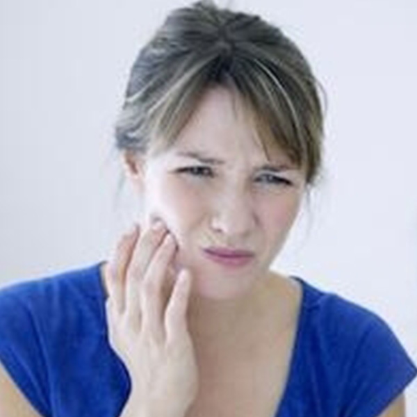 Woman having tooth pain on right cheek