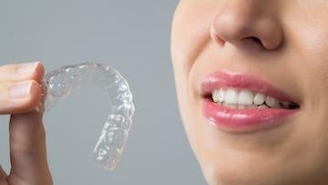 Woman holding a invisalign