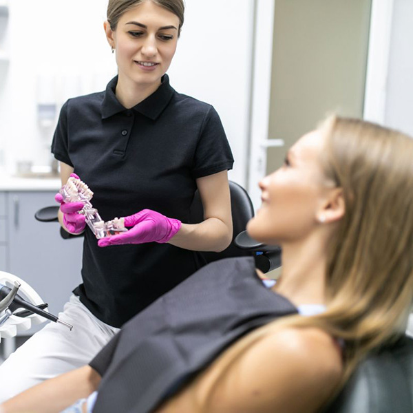 Dentist showing patient the root canal procedure