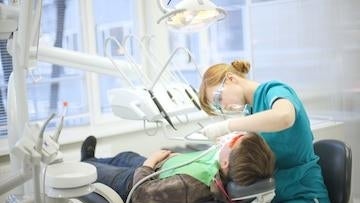 Dentist treating her patient