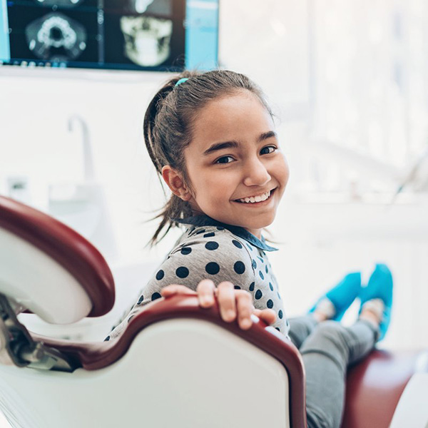 Little kid smiling at the dentist office