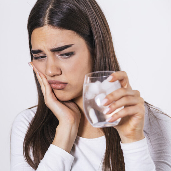 Woman feeling teeth sensitivity