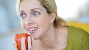 Woman eating an apple