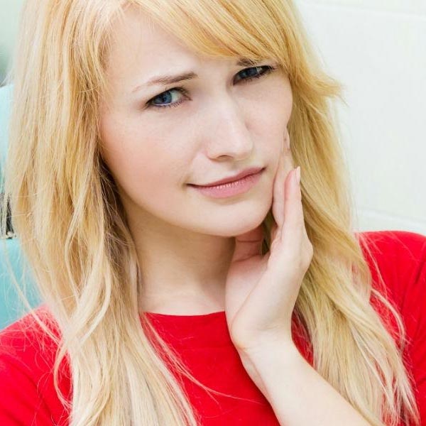 Woman having a toothache at the dentist office