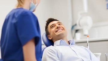 Male patient smiling at female doctor