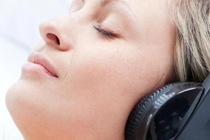 Young woman listening to music after successfully undergoing Snoring Treatments in Northern Phoenix
