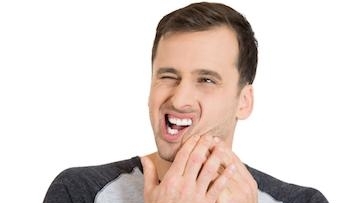 Young man having teeth pain