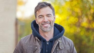 A man smiling Wearing woolen Cloth