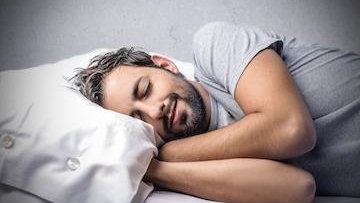 A man sleeping in Bed