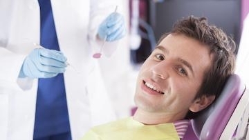Man smiling sitting on the dentist chair