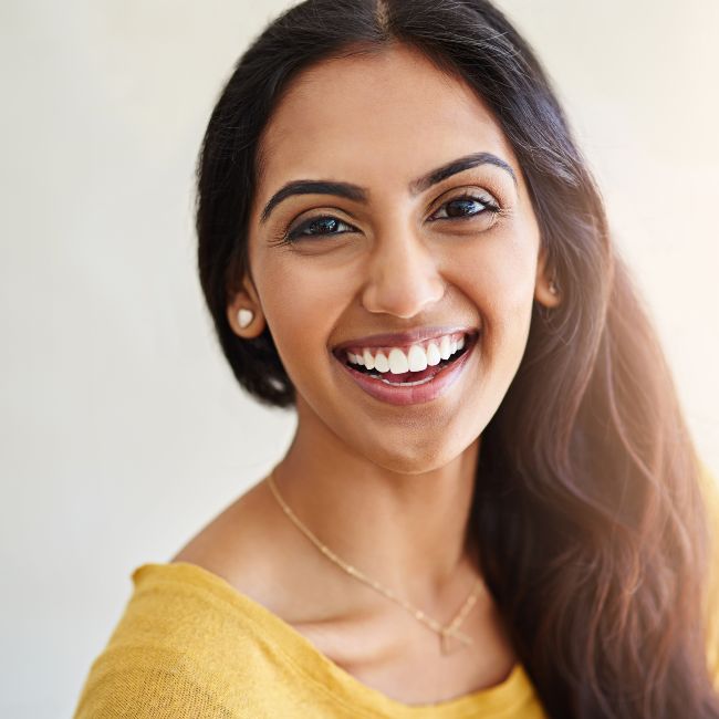 woman in yellow sweater smiling