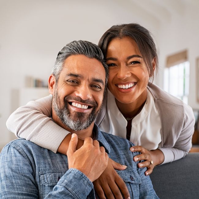 couple on sofa smiling in living room
