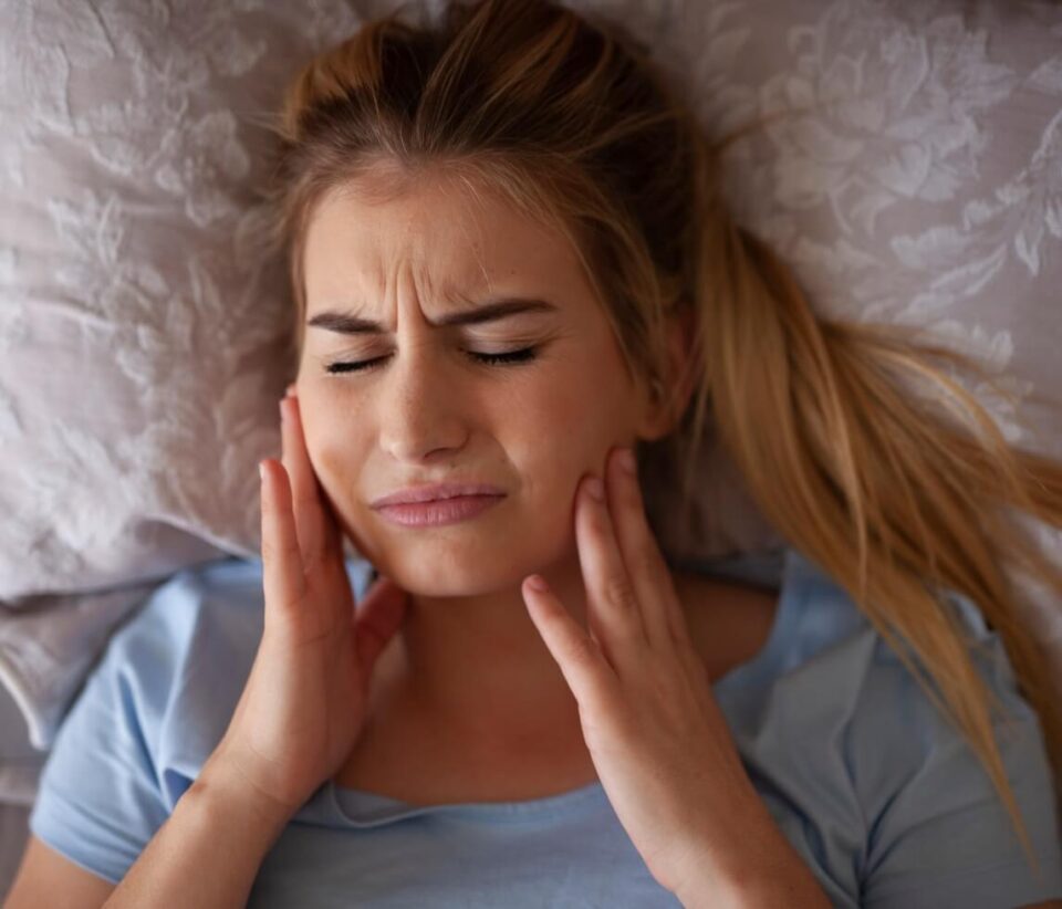 Woman in sleep experiencing teeth grinding in North Phoenix, AZ