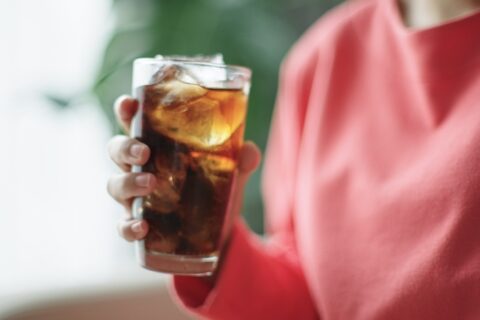 A woman is drinking Coke and is unaware of the sugar content in North Phoenix, AZ