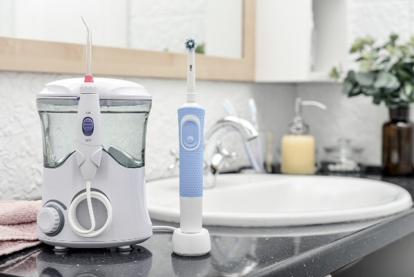 Electric oral irrigator and a rechargeable toothbrush