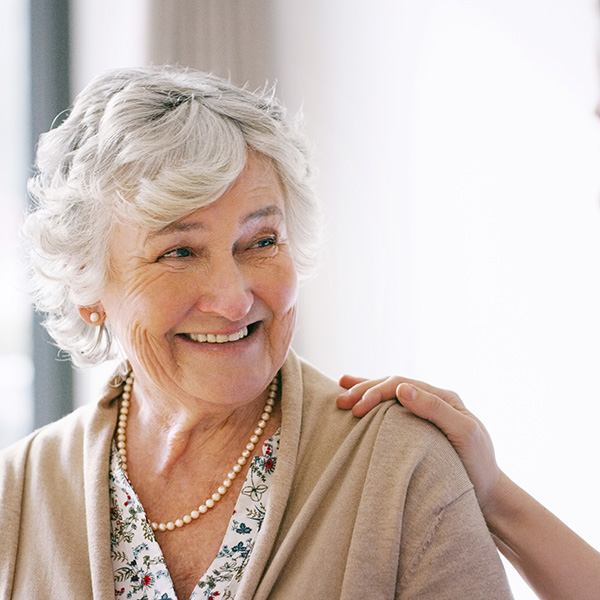 Elderly woman smiling showing her white teeth