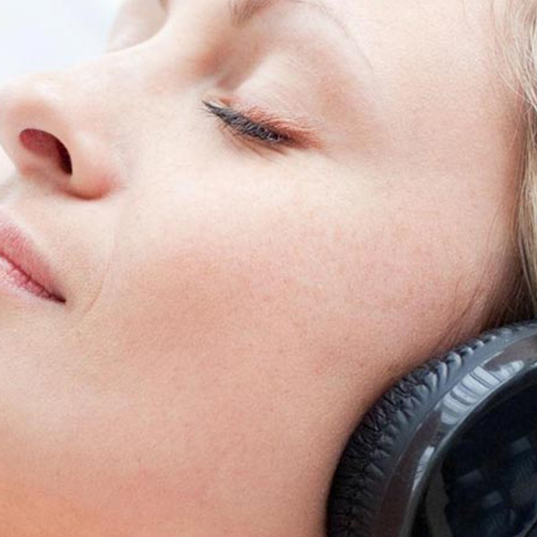 Woman wearing earphones to sleep