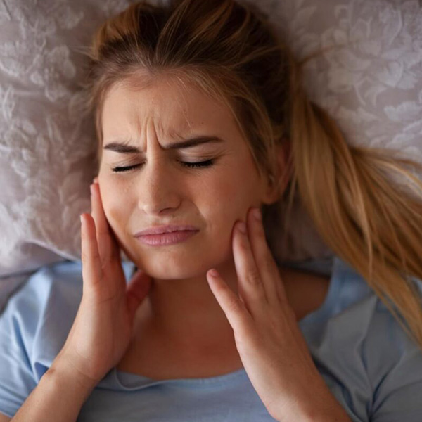 Woman having tooth pain on both cheeks