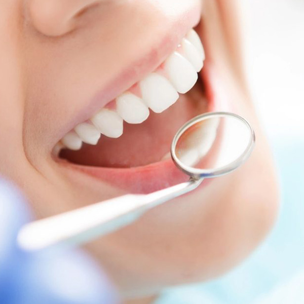 Woman smiling showing her white teeth getting ready for oral exam